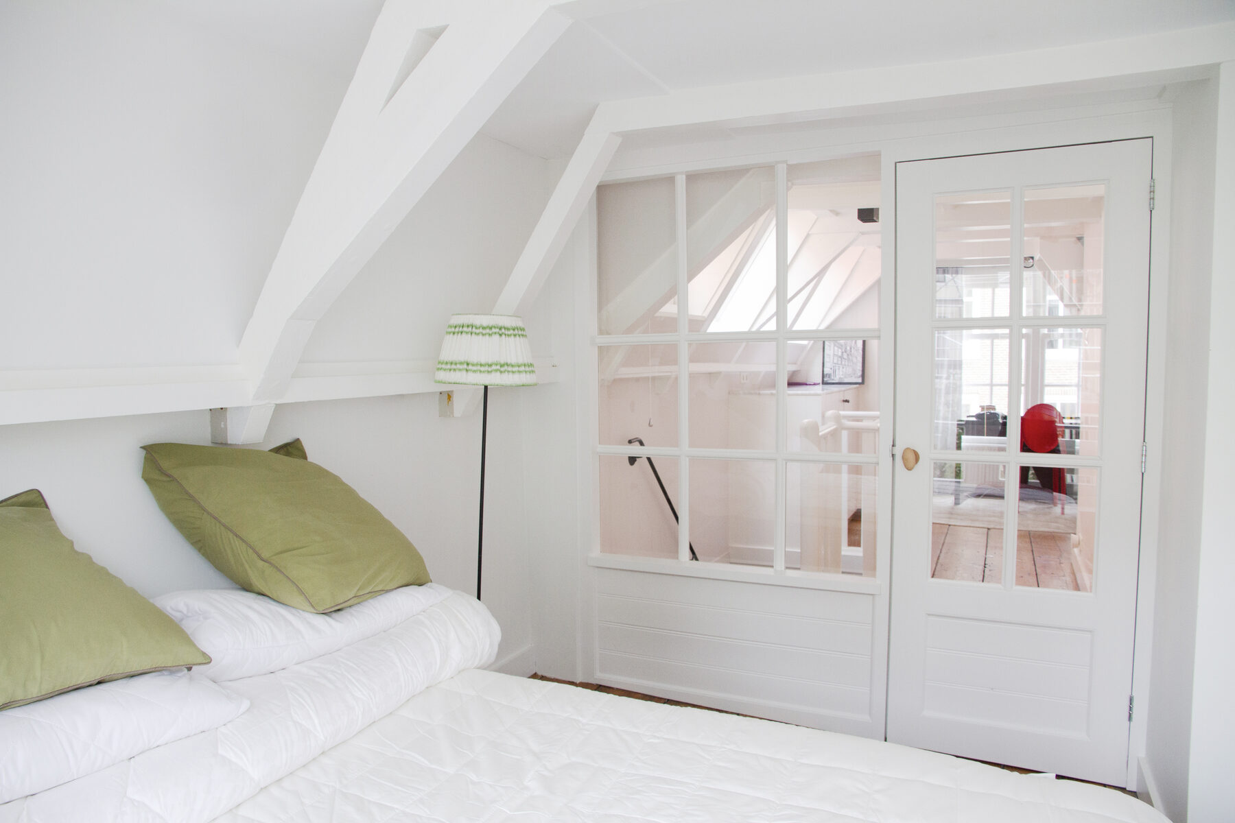 A serene bedroom with soft light and a made bed