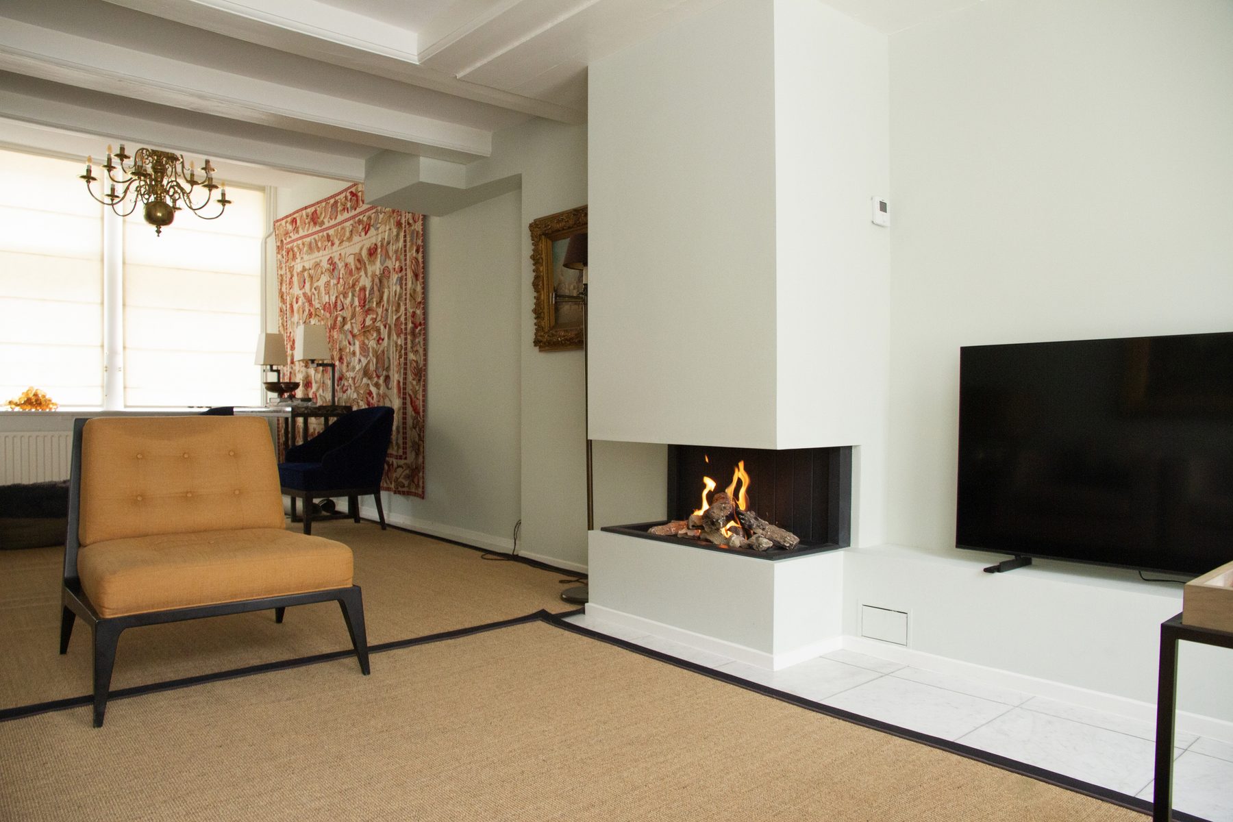 Living room with fireplace in a monumental house in central Amsterdam
